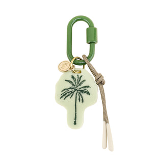 Keychain with palm tree design on a light green background
